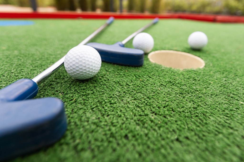 Mini,Golf.,Playing,Mini,Golf,With,Red,Ball.,Recreation,Game